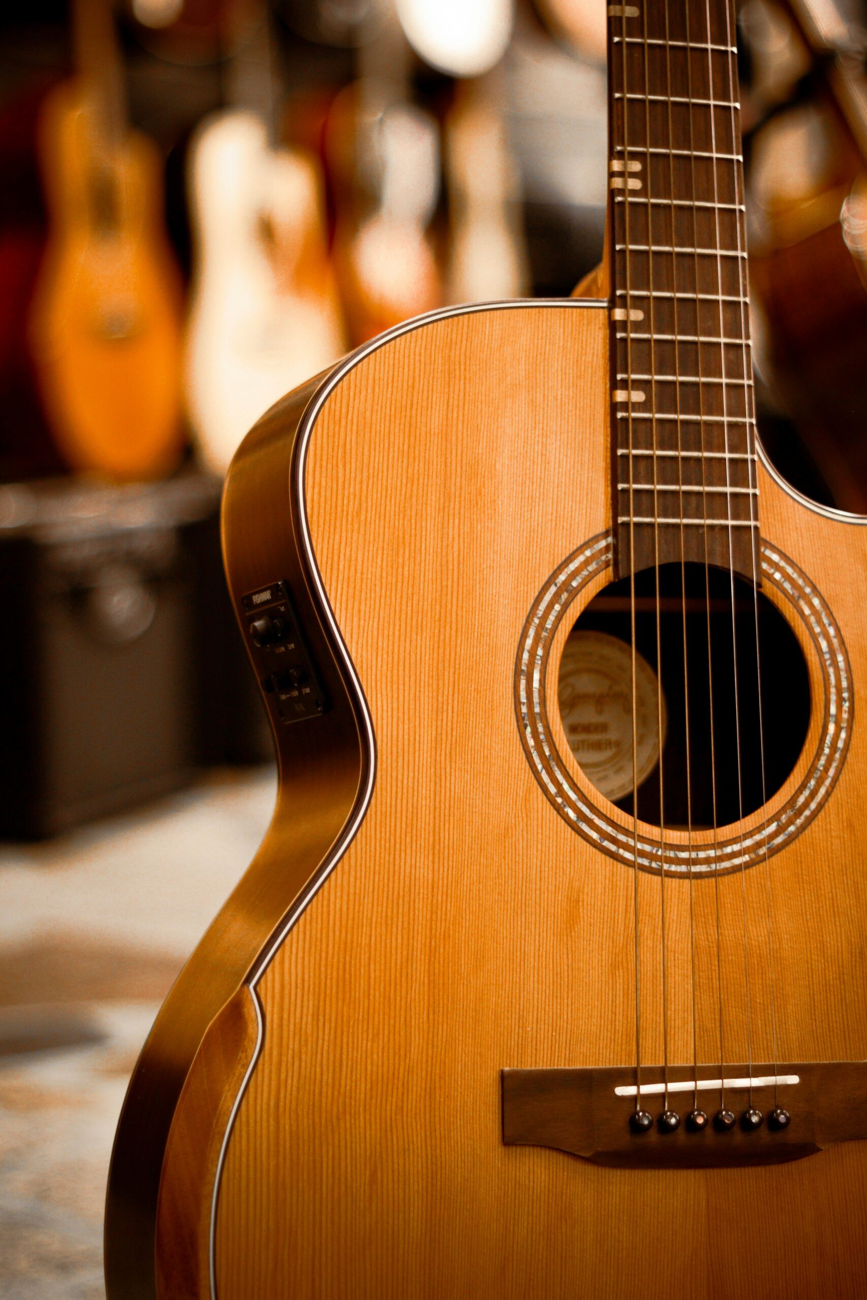 Detailed view of an acoustic guitar highlighting strings and wooden texture.