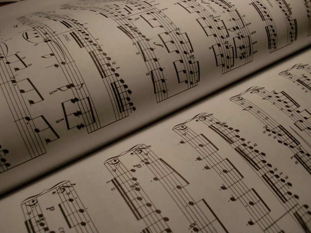 Detailed view of an open music book displaying musical notes and sheet music.